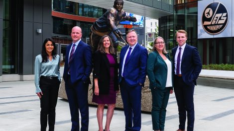 The Cardinal Sport team in front of the newly-unveiled statue of Winnipeg Jets legend Dale Hawerchuk in downtown Winnipeg. From left to right, Preeya Sharma, Greg Phillips, Diane Coughlin, Brian Coughlin, Leah Cochrane and Austin Coughlin.